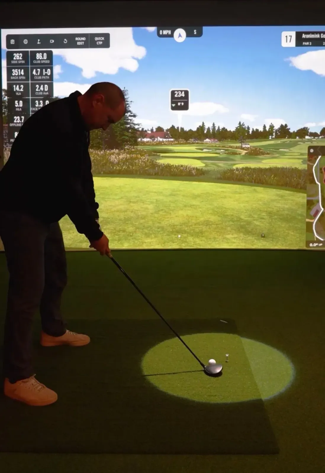 A golfer concentrating on lining up a shot at Virtual Fairways