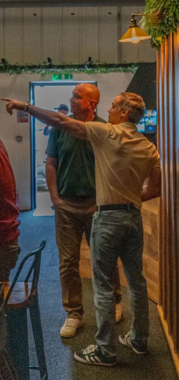 Friends chatting between shots at Virtual Fairways, Darlington